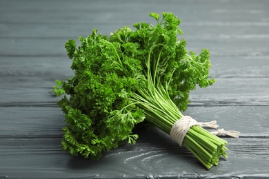 Bunch of fresh green parsley on wooden background