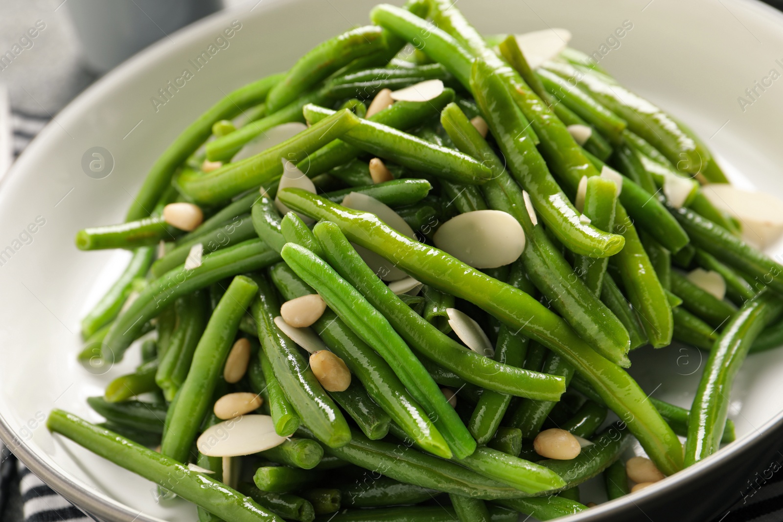 Photo of Bowl of tasty salad with green beans, closeup view