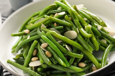 Photo of Bowl of tasty salad with green beans, closeup view