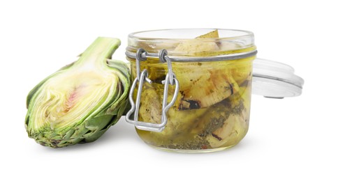 Open jar of delicious artichokes pickled in olive oil and fresh vegetable on white background