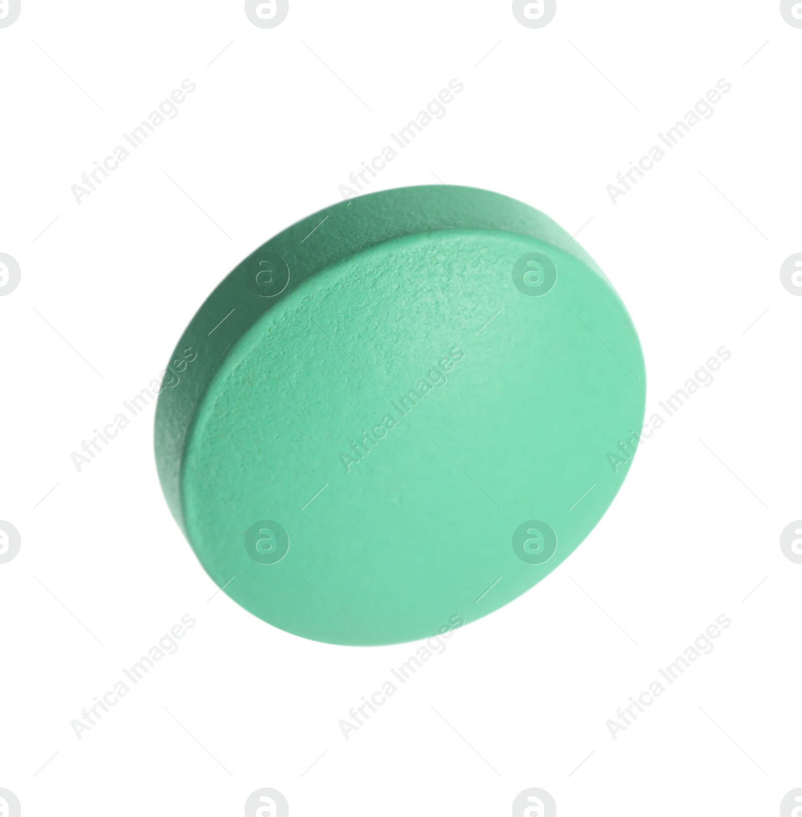 Photo of One green pill on white background. Medicinal treatment