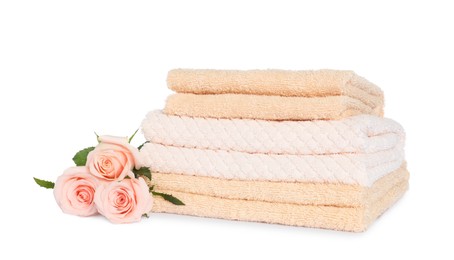 Stack of clean soft towels with flowers isolated on white