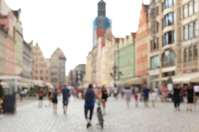 Blurred view of crowded city street on sunny day