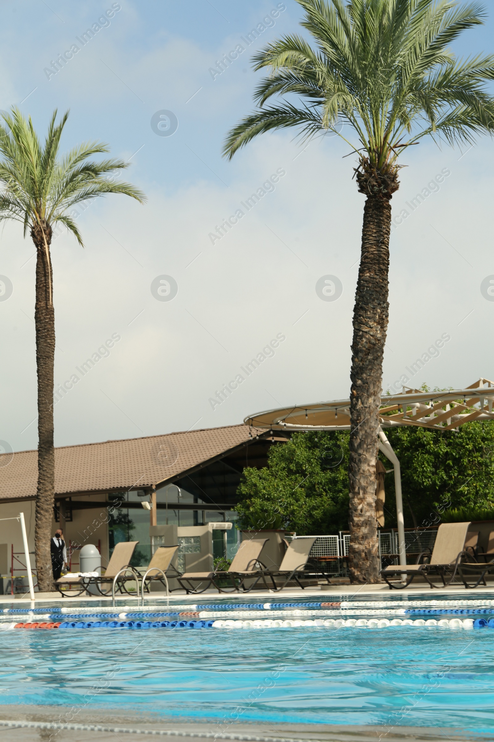 Photo of Swimming pool and sunbeds at luxury resort