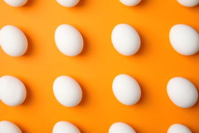 Raw chicken eggs on color background, top view