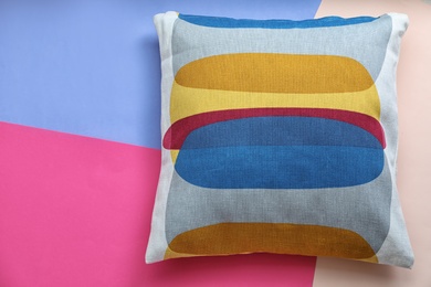 Photo of Soft decorative pillow on color background, top view