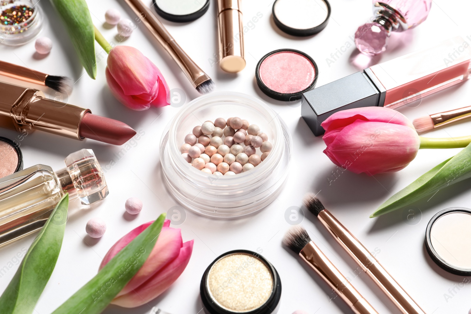 Photo of Different makeup products and flowers on white background