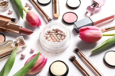 Photo of Different makeup products and flowers on white background