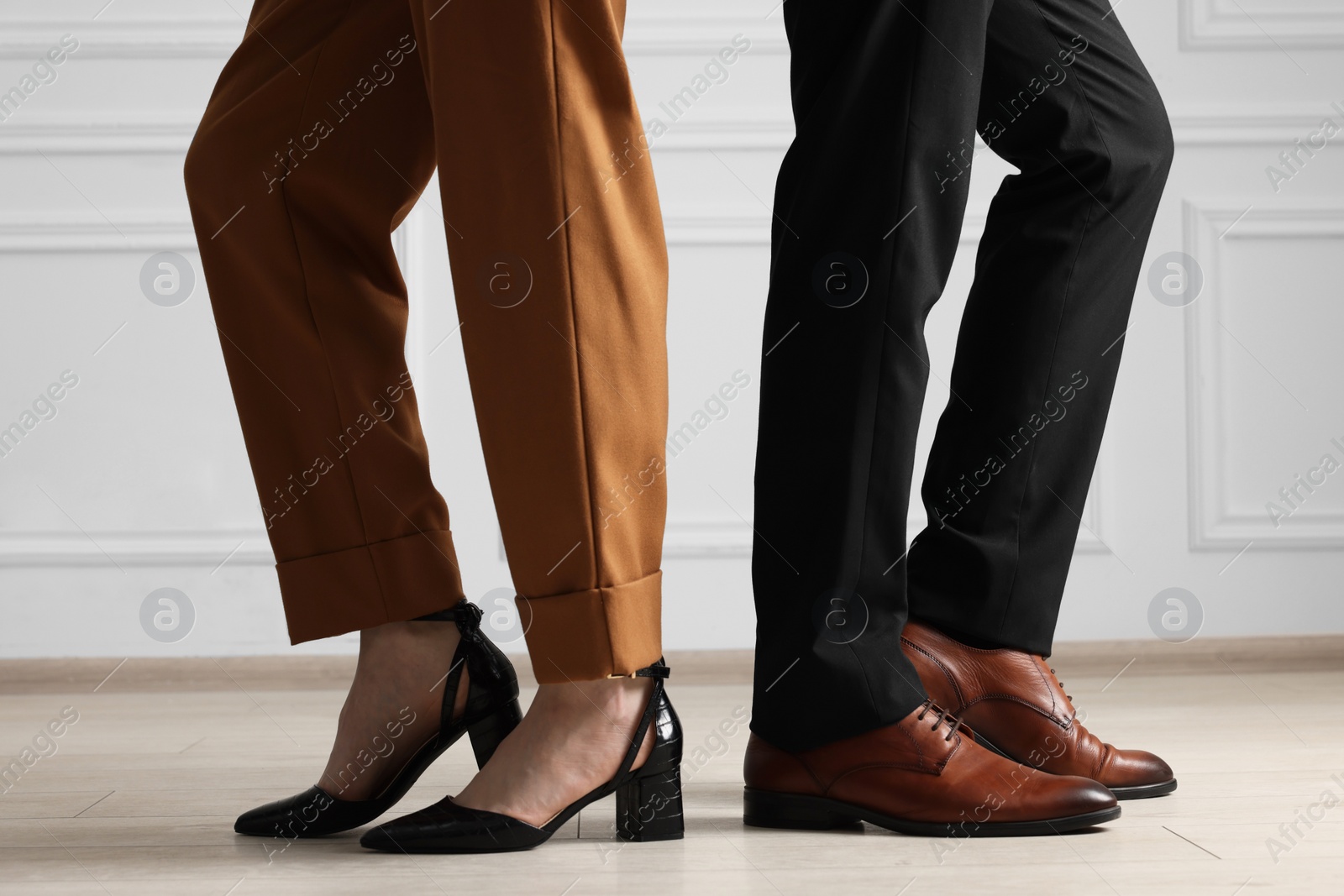 Photo of Businessman and businesswoman in elegant shoes indoors, closeup