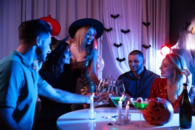 Photo of Group of friends having Halloween party at home