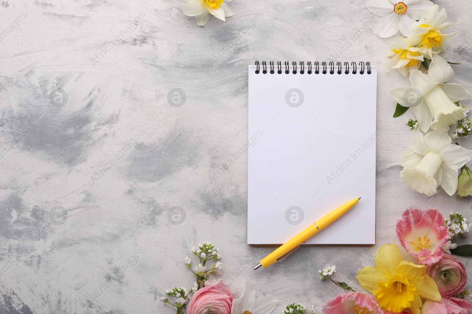 Photo of Guest list. Notebook, pen and beautiful flowers on gray textured background, flat lay. Space for text