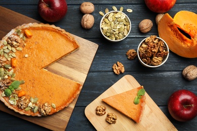 Flat lay composition with delicious fresh homemade pumpkin pie on black wooden table