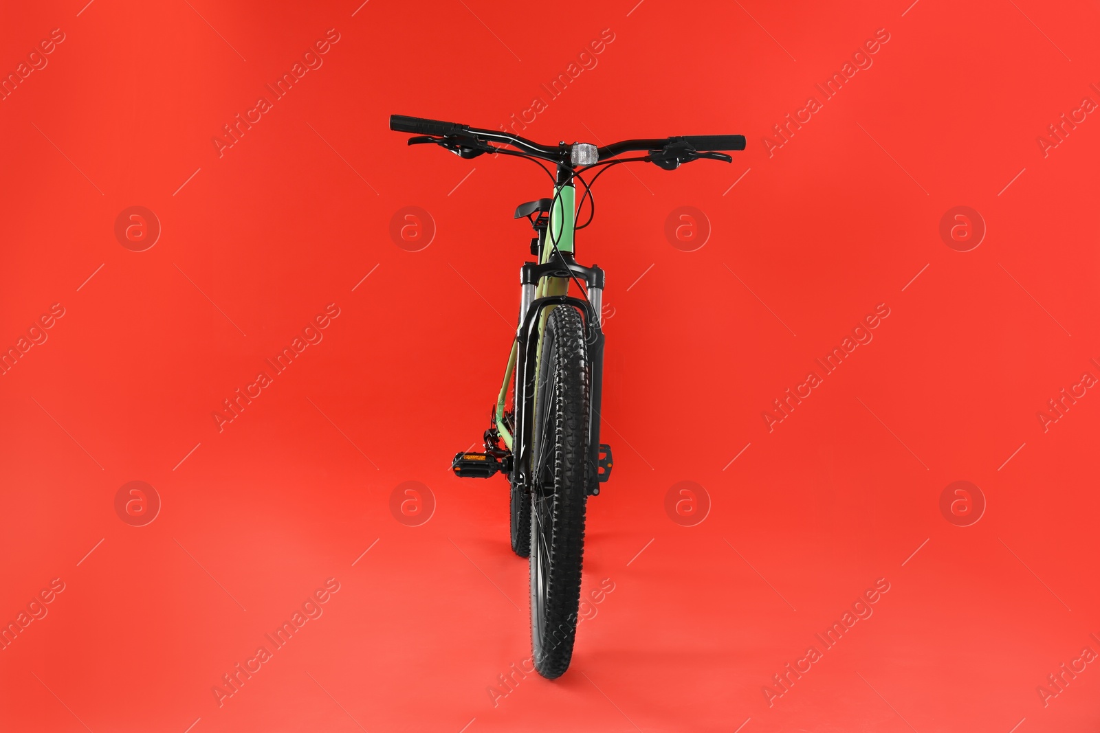 Photo of Modern bicycle on red background. Healthy lifestyle