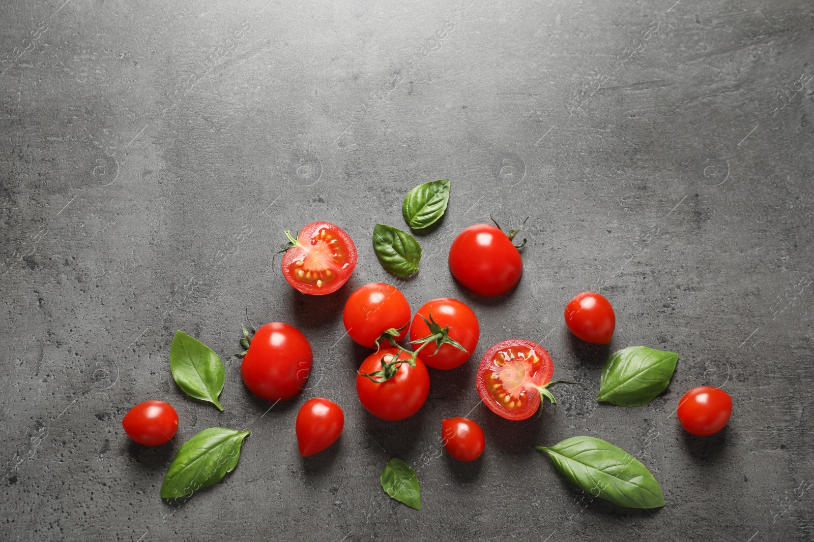 Photo of Flat lay composition with ripe cherry tomatoes and basil leaves on color background. Space for text