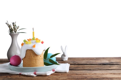 Photo of Beautiful Easter cake and painted eggs on wooden table against white background. Space for text