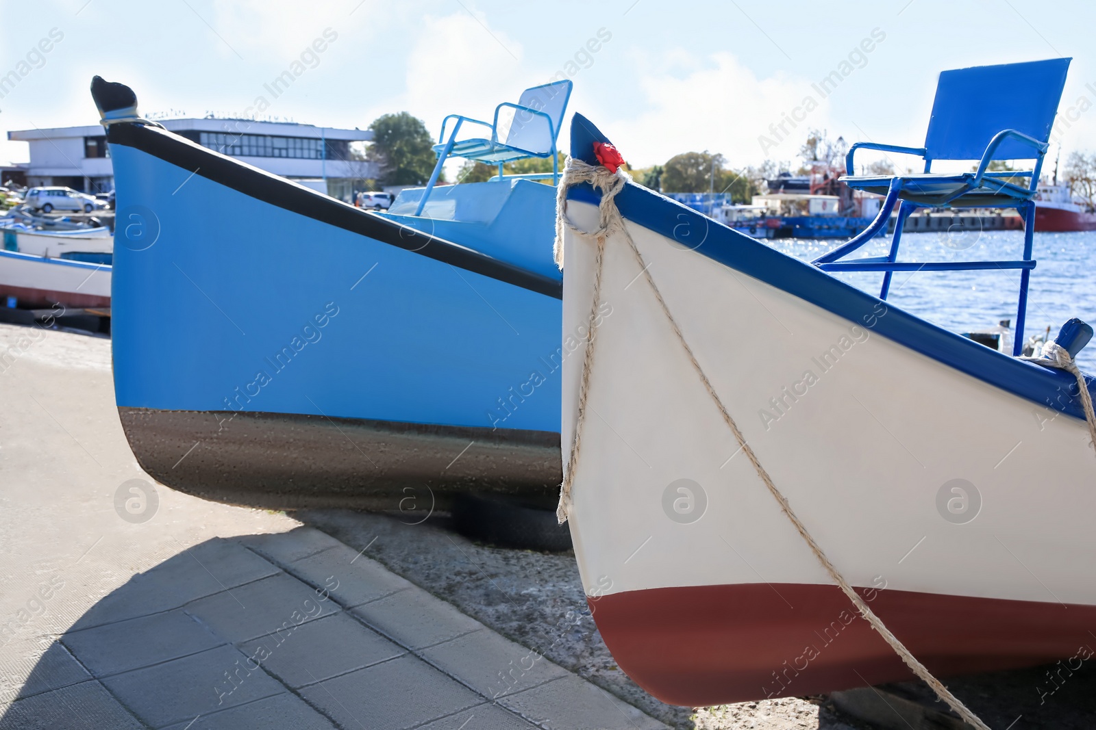 Photo of Pier with moored boats on sunny day, closeup