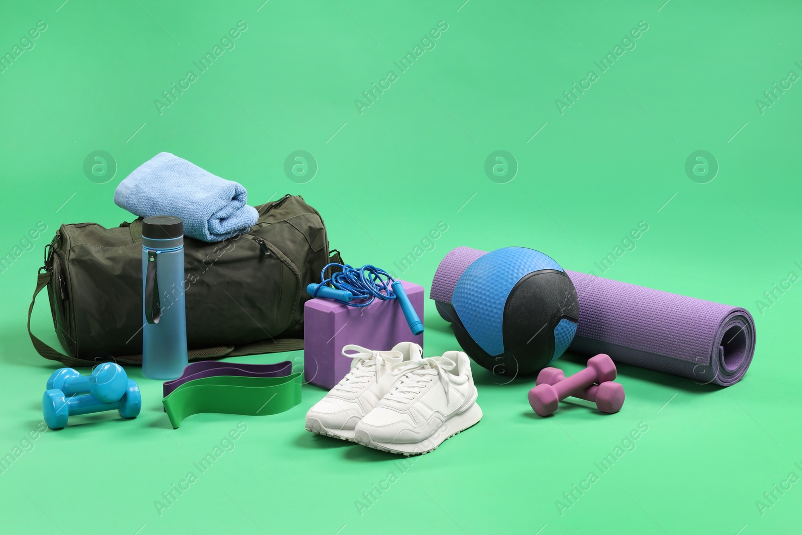 Photo of Many different sports equipment on green background