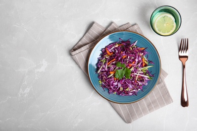 Plate with chopped red cabbage on table, top view