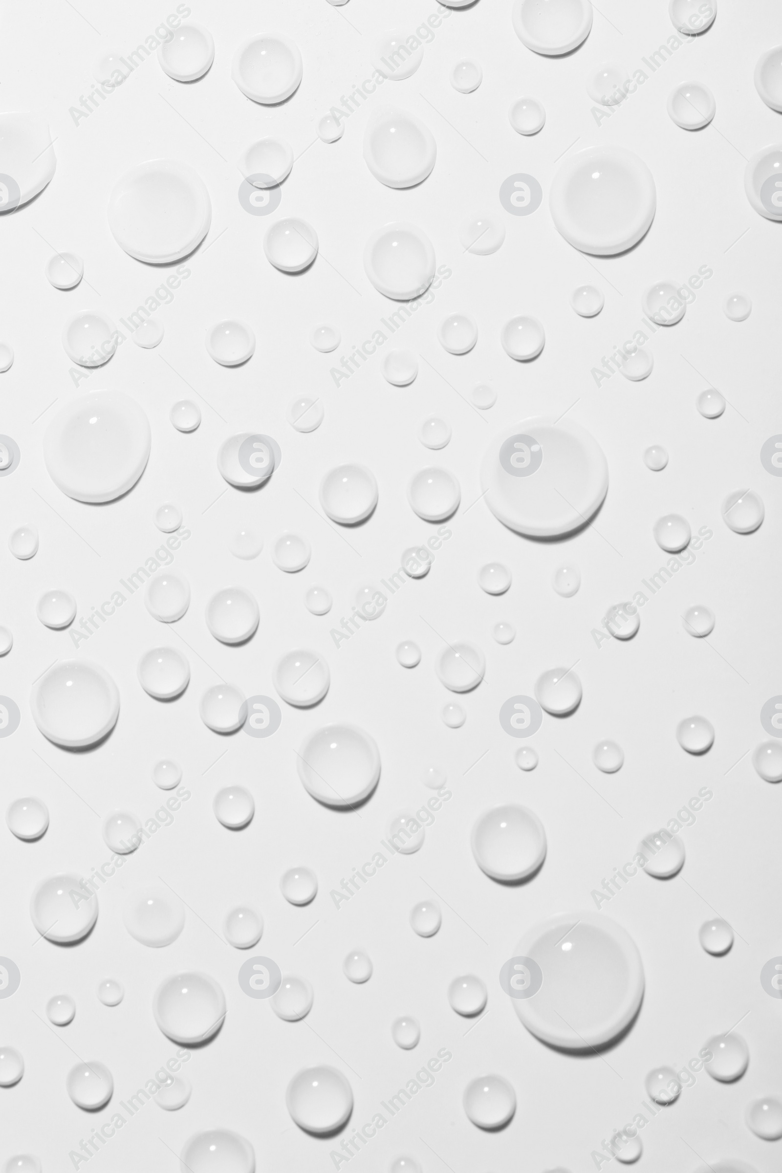 Photo of Water drops on white background, top view