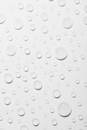 Water drops on white background, top view