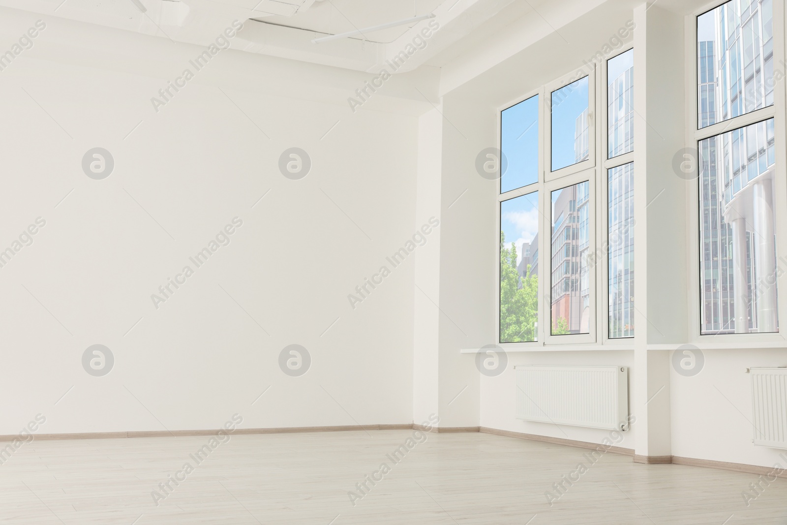 Photo of Modern office room with white walls and windows. Interior design