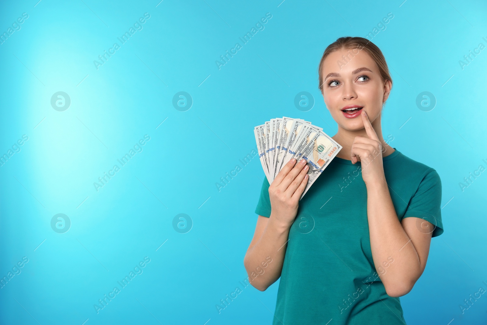 Photo of Portrait of thoughtful young woman with money on color background. Space for text