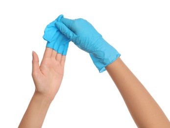 Doctor taking off medical gloves on white background, closeup