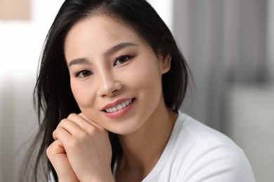 Portrait of beautiful woman with perfect skin at home