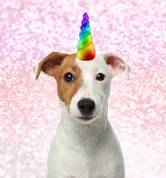 Image of Cute dog with rainbow unicorn horn on blurred sparkling background
