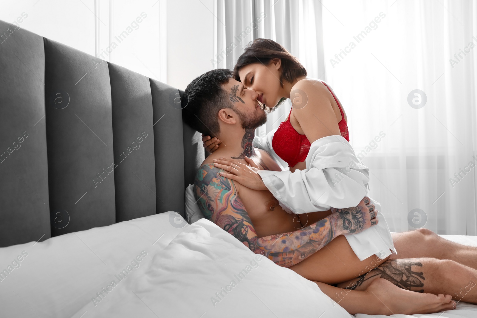 Photo of Passionate couple having sex on bed at home