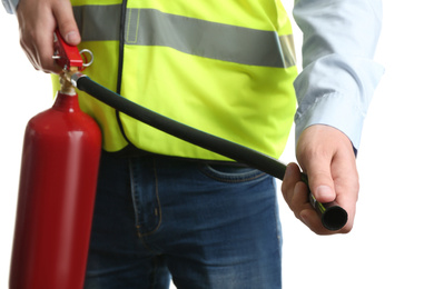 Worker using fire extinguisher on white background, closeup