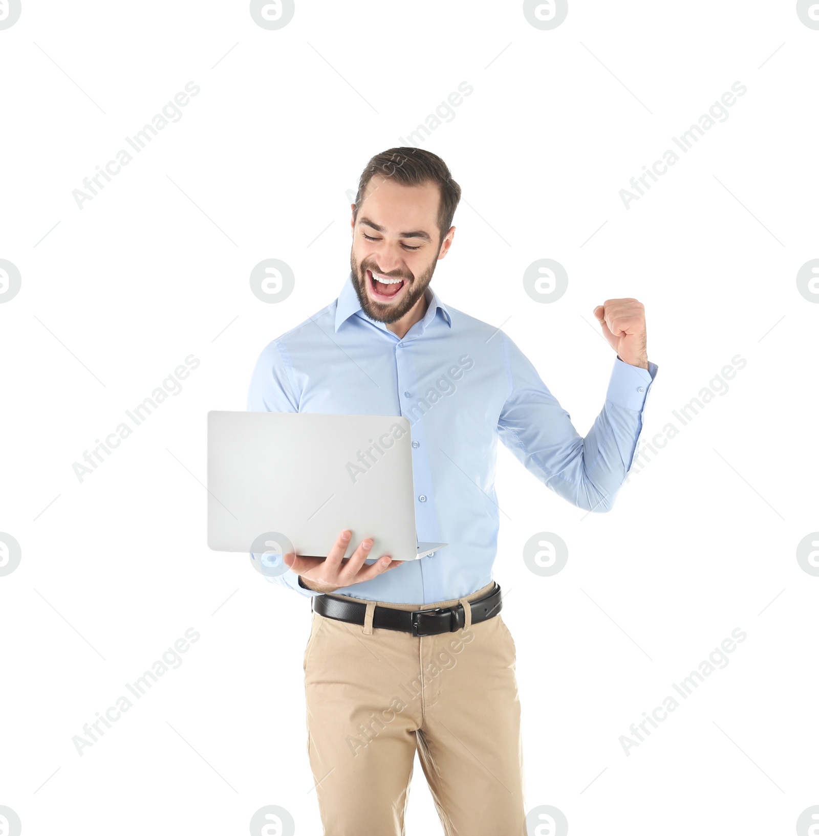 Photo of Emotional young man with laptop celebrating victory on white background