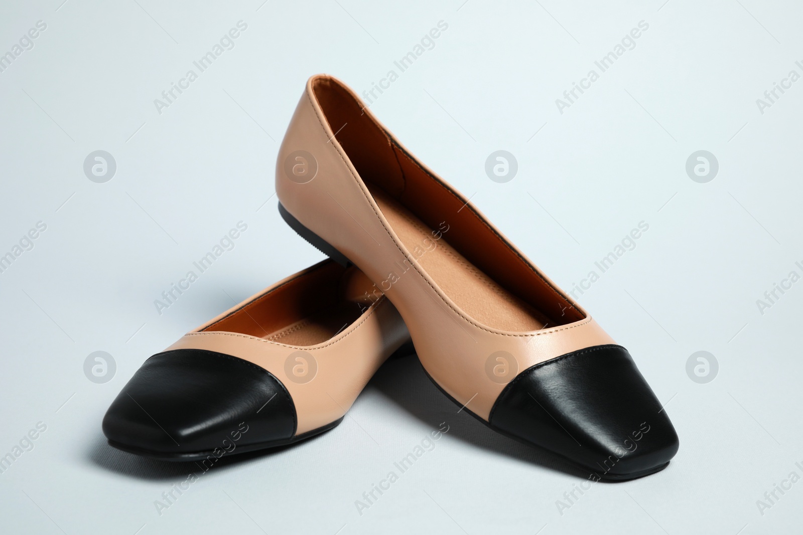 Photo of Pair of new stylish square toe ballet flats on light grey background