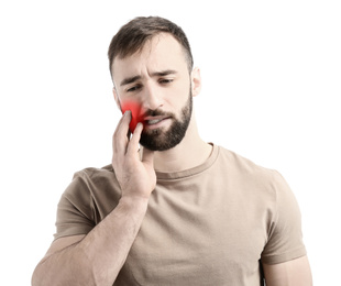 Image of Young man suffering from toothache on white background