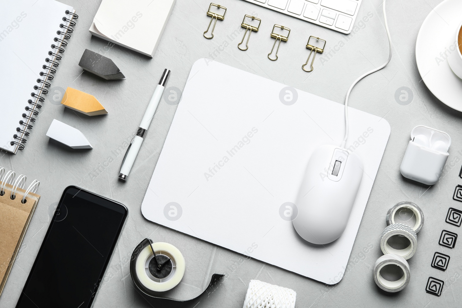 Photo of Flat lay composition with wired computer mouse and stationery on light grey table