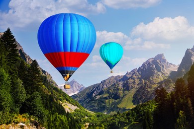 Image of Bright hot air balloons flying over mountains