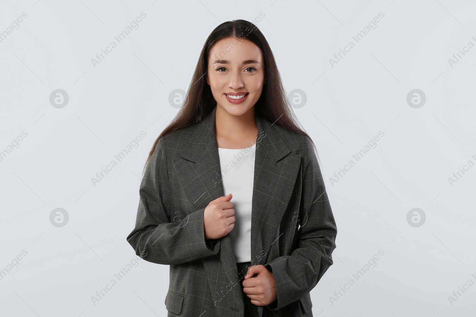 Photo of Portrait of happy young woman in stylish jacket on white background