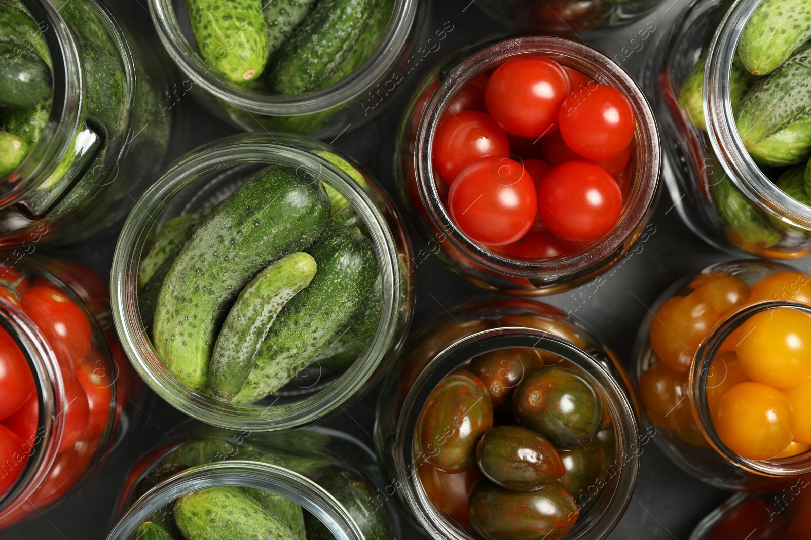 Photo of Pickling jars with fresh vegetables on table, flat lay