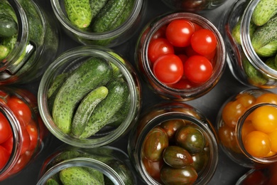 Photo of Pickling jars with fresh vegetables on table, flat lay