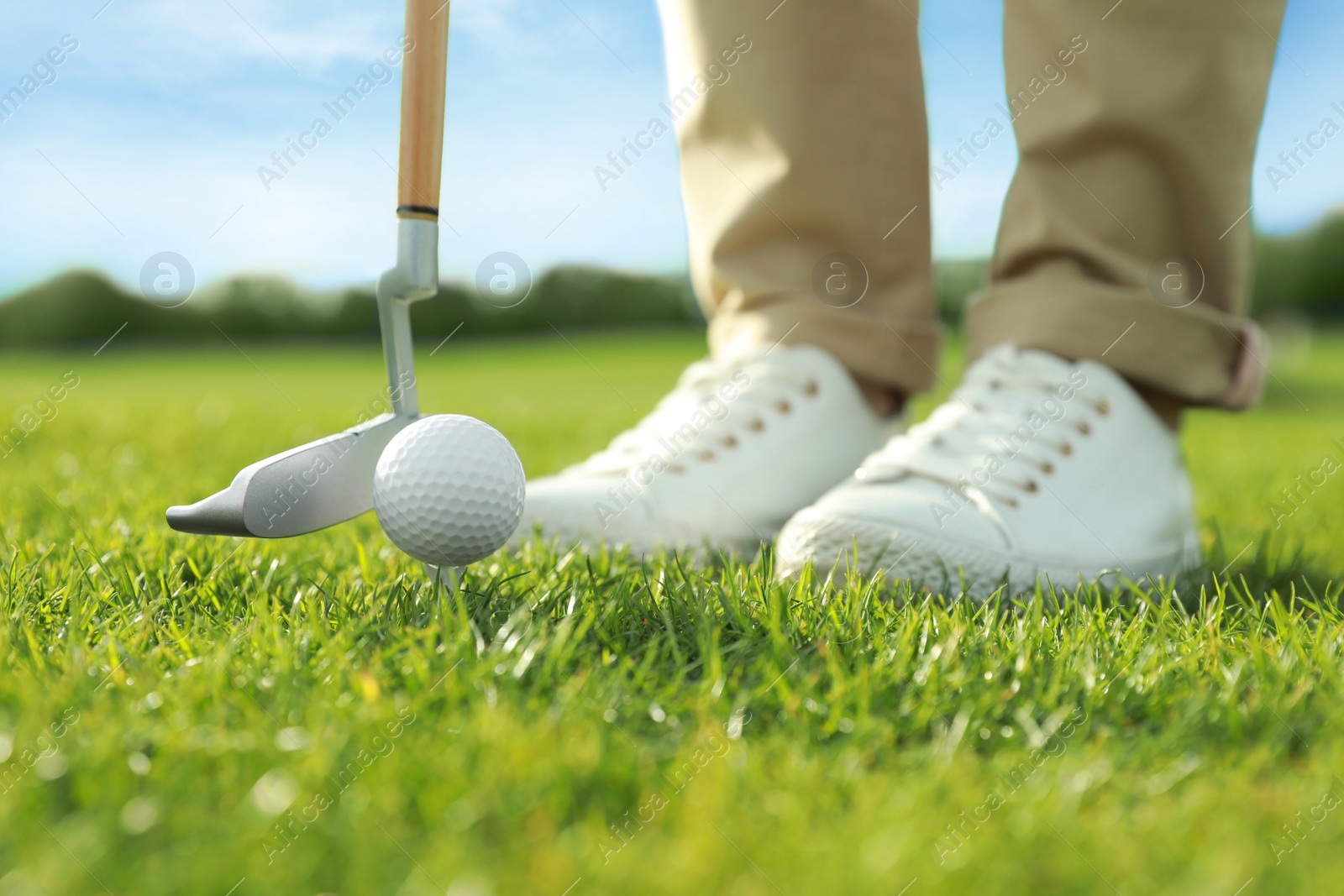 Photo of Person playing golf on green course, closeup