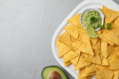 Photo of Flat lay composition with tasty Mexican nachos chips on grey table, space for text