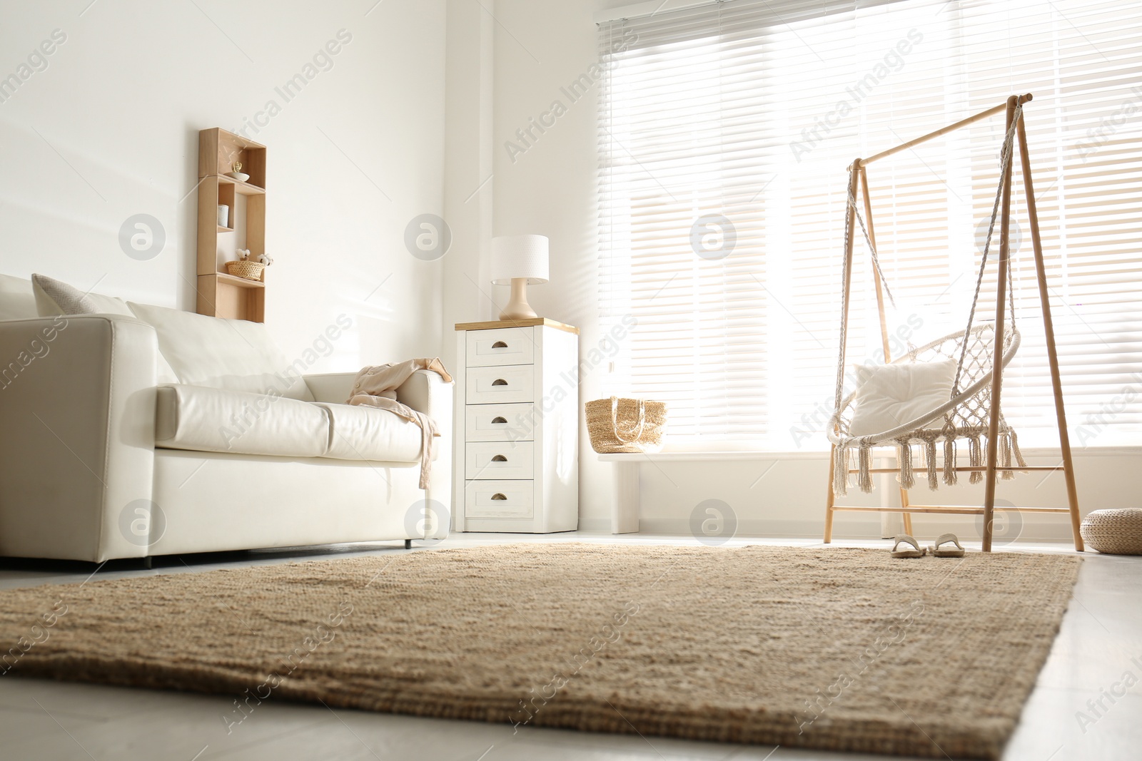 Photo of Comfortable hammock chair in stylish room. Home interior