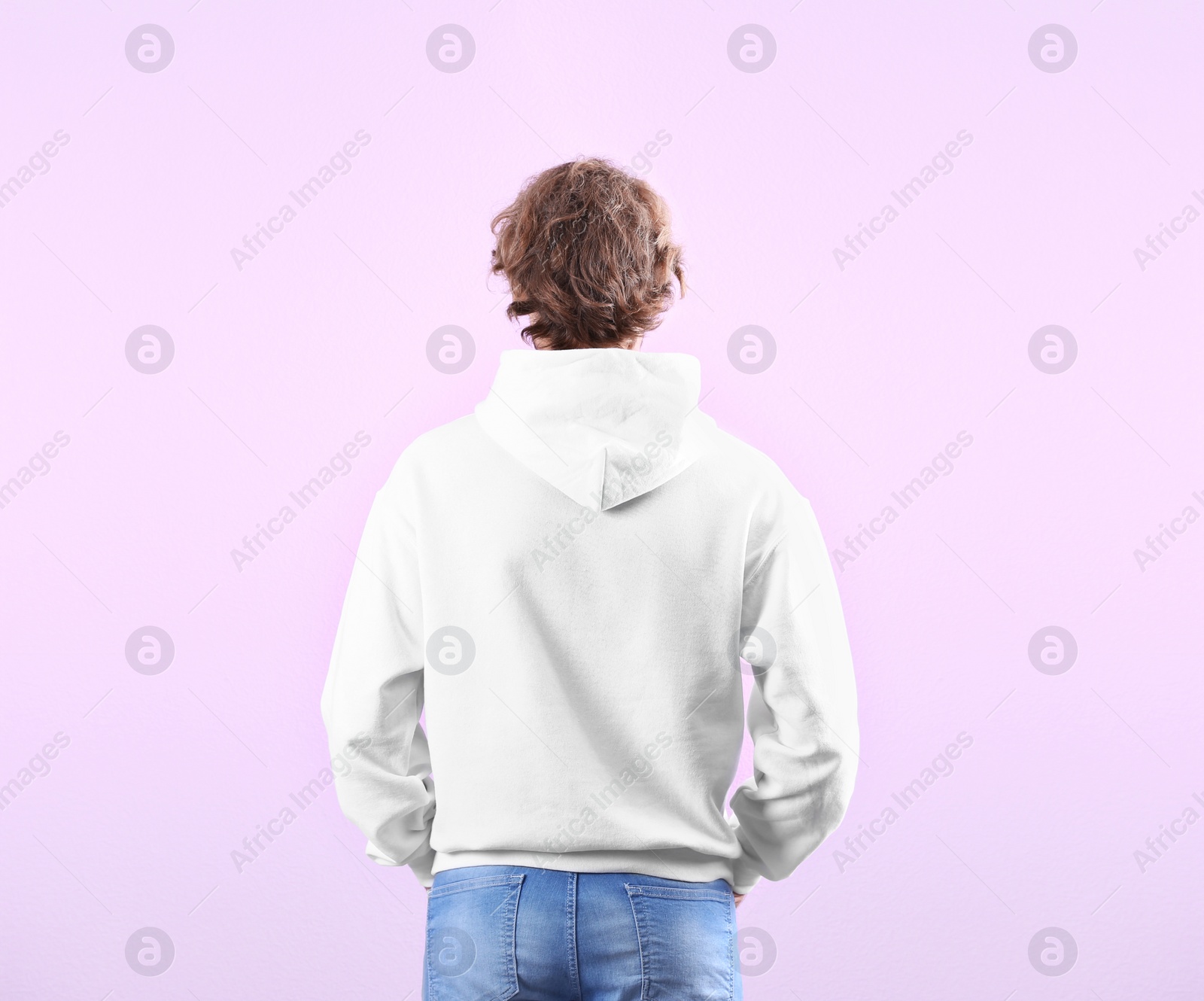 Photo of Man in hoodie sweater on color background. Space for design