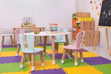 Stylish kindergarten interior with toys and modern furniture