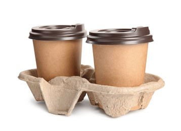 Takeaway paper coffee cups in cardboard holder on white background