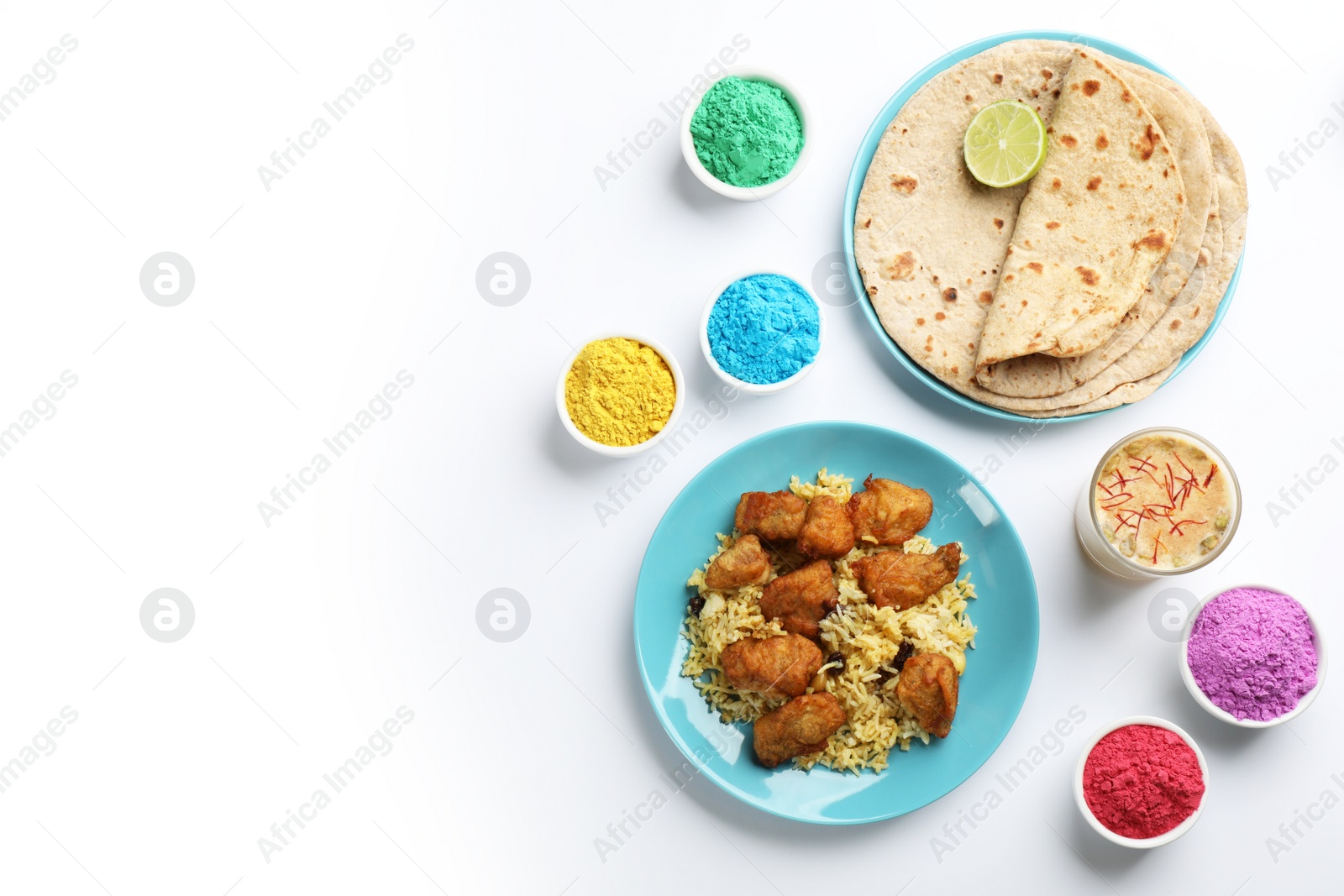 Photo of Flat lay of traditional Indian food and color powder dyes on light background, space for text. Holi festival