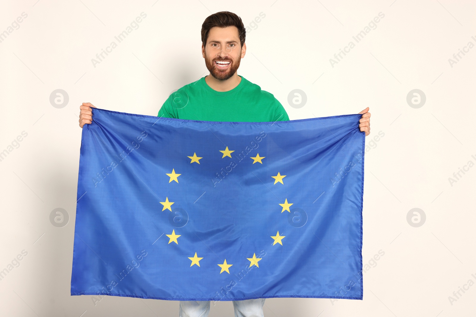 Photo of Man with flag of European Union on white background