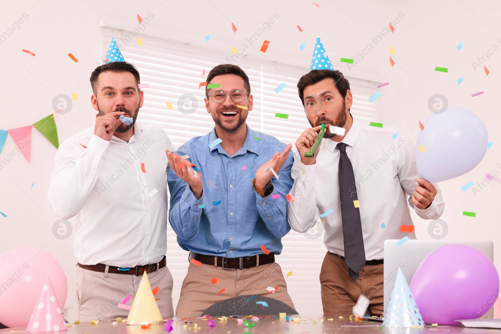 Photo of Coworkers having fun during office party indoors