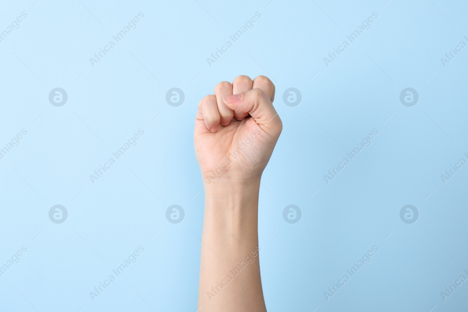 Photo of Woman showing S letter on color background, closeup. Sign language