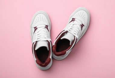 Photo of Pair of stylish shoes on pink background, top view